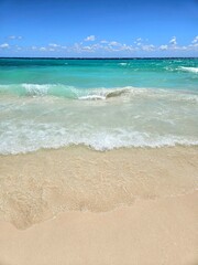 Tropical beach with blue sky, clouds and sand