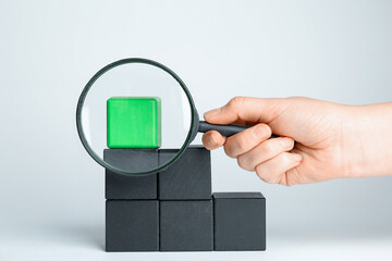 Woman with magnifying glass exploring stairs made of different cubes on white background, closeup....