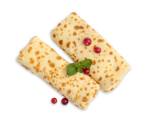 Delicious rolled crepes with cranberries and mint isolated on white, top view