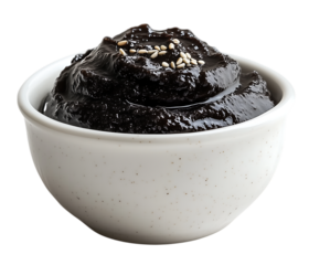 Fresh Korean black bean paste (chunjang) in a white ceramic bowl on transparent background