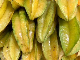 A pile of freshly picked large Indonesian yellow starfruit.