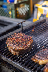 Juicy steaks sizzle alluringly on the grill, showcasing beautifully charred marks and mouthwatering flavors that bring joy to barbecue lovers, particularly during the warm summer months