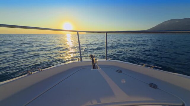 Boat bow sailing cruising in mediterranean blue sea sunrise