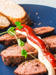 Rye bread toast with microgreens and mayonnaise and ketchup sauce on a blue plate. High quality photo