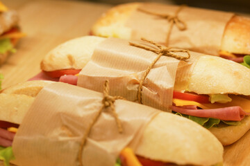 Freshly made sandwiches wrapped and prepared for takeout service