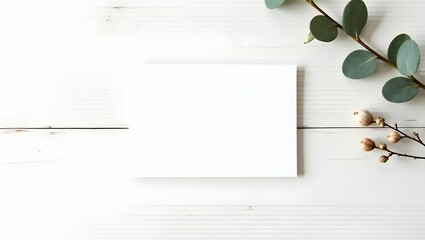 Elegant mockup featuring a blank card with botanical elements on white wooden background