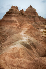 A scenic view of the Badlands, featuring majestic geological formations and a rugged terrain that highlights the raw beauty and timelessness of this unique landscape.