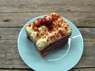 delicious piece of cherry cake covered with icing and cherries. High quality photos