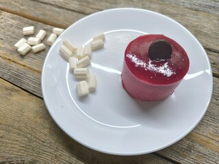 thin almond sponge cake in the base, creamy raspberry mousse. High-quality photo