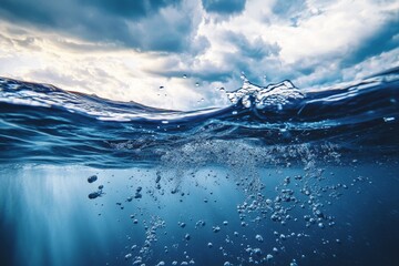 Underwater scene  calm blue water reflects stormy sky with dynamic splash and rising bubbles
