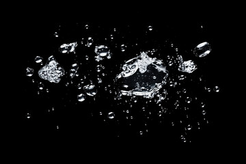 Obraz premium Water droplets suspended in mid-air after a splash, frozen in time, with copy space. High-speed photography lighting. Abstract liquid background. 