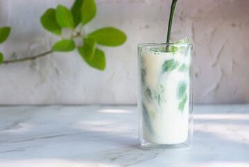 ice matcha latte on white table.