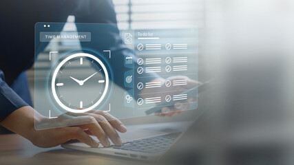 Time management and productivity tools. business professional working on a laptop with clock and to...