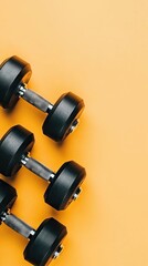 Obraz premium Fitness dumbbells, yellow background, workout, exercise, health