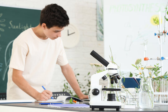 Modern microscope on table in Biology class at school, closeup