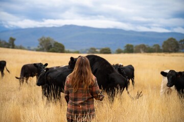 female regenerative organic farmer, taking soil samples and looking at plant growth in a farm. women in agriculture practicing sustainable agriculture good looking farmer