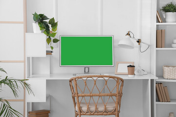Modern workplace with computer near white wall in room