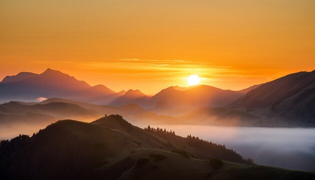 golden sunrise over mountain range in morning mist