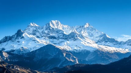 Obraz premium Majestic Snowcapped Mountain Range Under a Clear Blue Sky