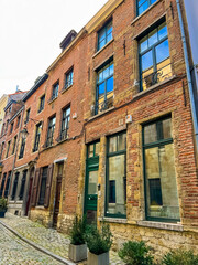 Charming old townhouse in brussels with green doors and red brick walls, Belgium