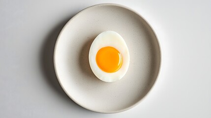 Close up of Soft Boiled Egg Halves Served on a Minimalistic Ceramic Plate Showcasing the Rich Creamy Yolk in a Simple Elegant Food Photography Setup