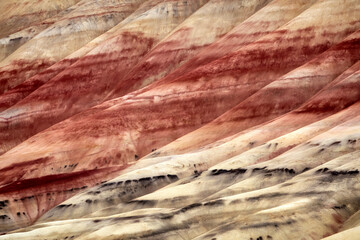 The striking patterns of colorful striped layers at Painted Hills reveal stunning hues of red,...