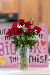 Bunch of Red roses with valentine card in background