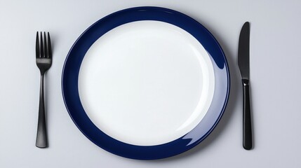 Minimalist Table Setting with Blue Trim and Black Cutlery