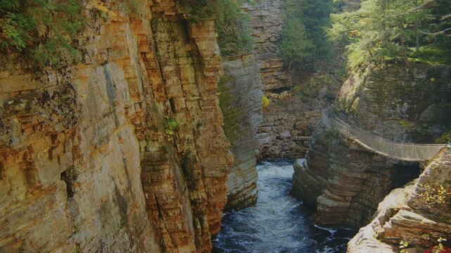 An amazing 4K shot of the Ausable Chasm Canyon, with the river flowing through the rugged terrain, set against the mountain backdrop in Keeseville, NY.