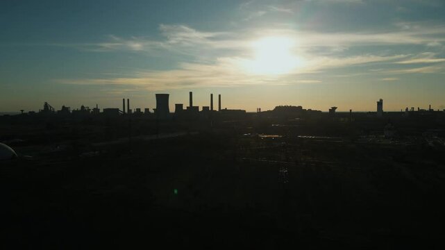 Sunny Afternoon With Silhouette Of Industrial Towers Of Steel Plant In Galati, Romania. descending drone shot