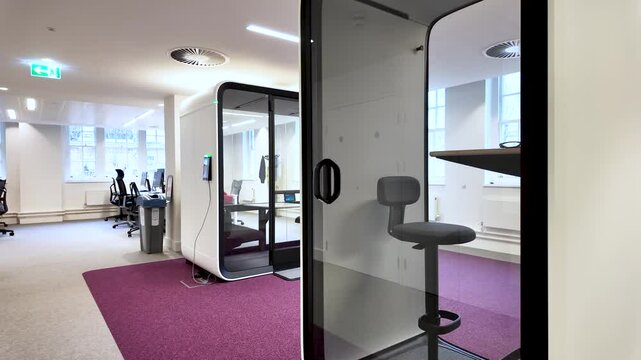 Soundproof pods providing quiet space for focused work or private calls in a modern office setting, enhancing productivity and concentration