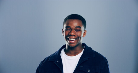 Obraz premium Happy, student and portrait of black man in studio with smile for scholarship, registration and college application. Mockup space, gray background and person for education, university and school