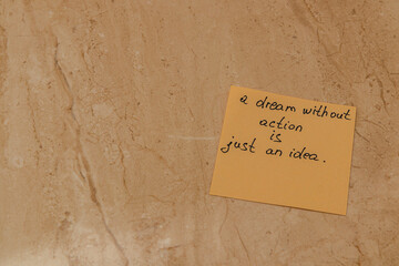 Motivational quote on sticky note captured in a warm, serene setting