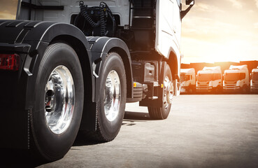 Semi  Trucks on The Parking Lot at The Port. Semi Truck Tractor, Big Rig. Truck Wheels Tire. Shipping Import- Export. Trucking. Freight Truck, Logistics Transportation.	