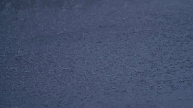 Slow Motion Rain Drops Falling on Assfault Road