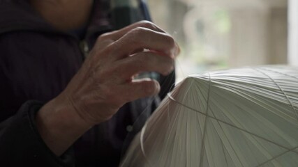 Handmade non la conical hat making in traditional Vietnamese village workshop - Powered by Adobe