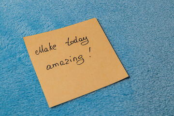 Inspirational note on a blue background encouraging a positive mindset