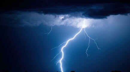 A striking lightning bolt cuts through a stormy blue sky.