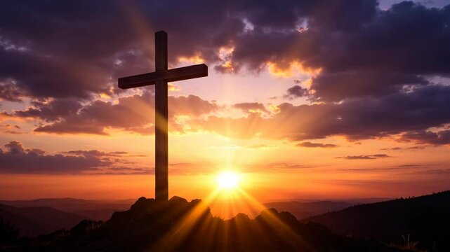 Wooden cross on a hill at sunset