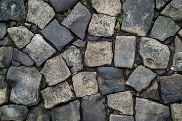 Obraz premium Worn cobblestone fragments with cracked surfaces broken stone slabs for vintage display