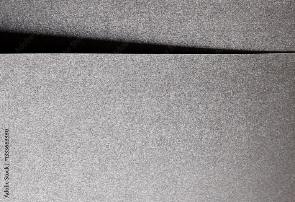 Poster gray metallic paper background with a glossy, satin finish and pearlescent texture. shiny silver ton