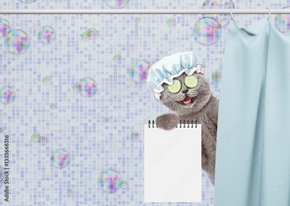 Fototapete Laughing cat with shower cap on it head and with slices of cucumber on it eyes peeking out from behind the curtain in the bathroom at home and showing blank notepad. Empty space for text