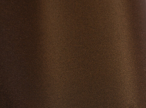 Rich brown paper background with a smooth, grainy texture and a subtle metallic shimmer. Warm gold and bronze tones create an elegant, luxurious design with a minimalistic gradient effect