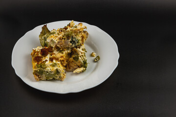 Savory casserole with chicken, broccoli, and garlic served on a plate