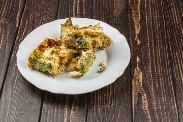 Delicious casserole with broccoli, chicken fillet, and garlic topping