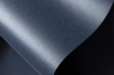 Blue paper background with a smooth, glossy texture and pearlescent finish. Deep, cool tones with a...