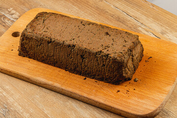Homemade chicken liver pate served on a wooden cutting board