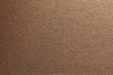 Elegant paper background with a smooth, grainy texture and a pearlescent finish. Warm gold and bronze tones create a luxurious, chic design with reflective shimmer and subtle shadows, perfect as a.