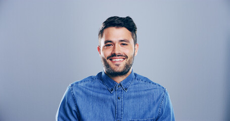 Portrait, smile and space with designer man in studio for artistic, creative or freelance profession. Career, internship and publisher with happy entrepreneur on gray background mockup for journalism