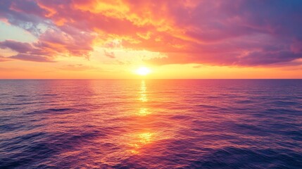 Obraz premium Vibrant Sunset Sky with Hues of Orange, Pink, and Purple Over Water